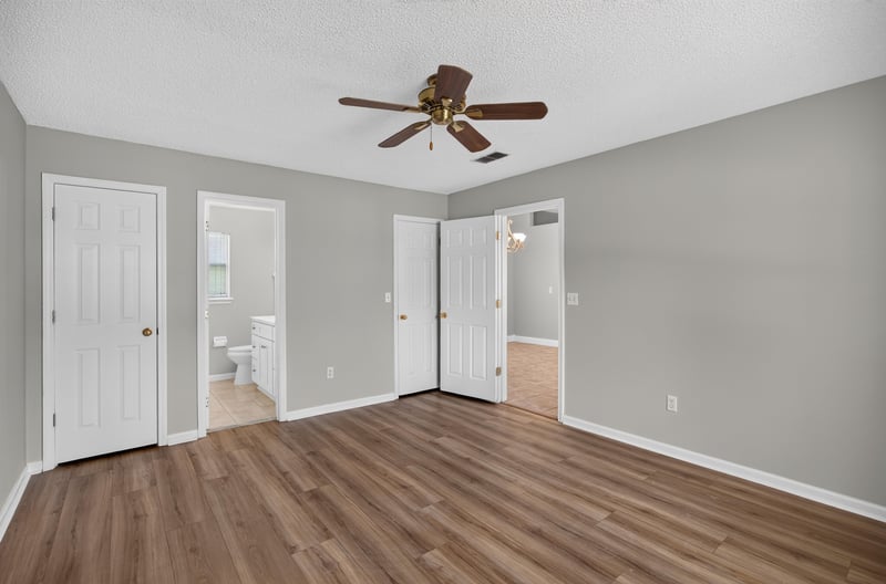 Bedroom with wood floor and closet doors at 9256 Dale View Ln W, Jacksonville, FL 32225