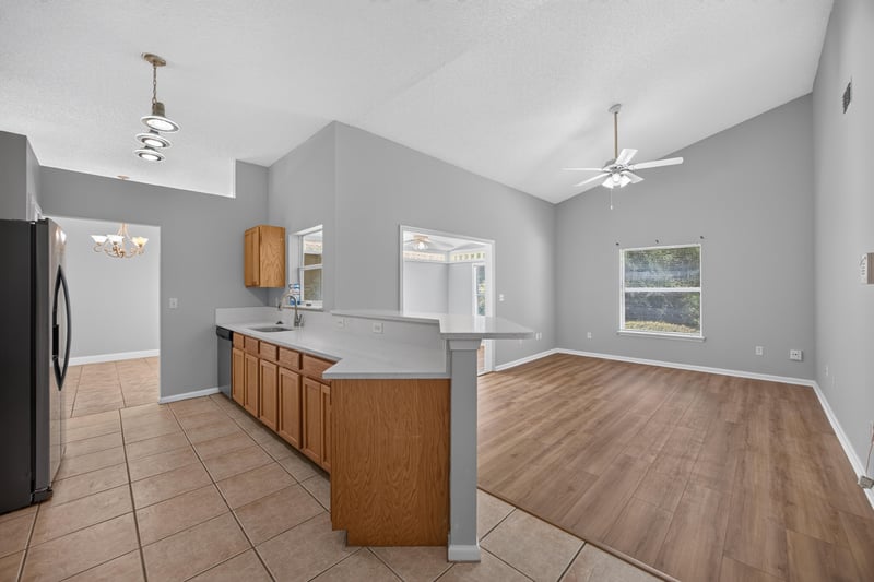 Kitchen peninsula with wood cabinets at 9256 Dale View Ln W, Jacksonville, FL 32225