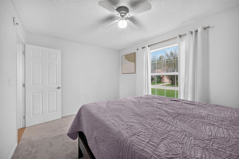 Bedroom with bed and curtained window at 8921 Needlepoint Pl, Jacksonville, FL 32244