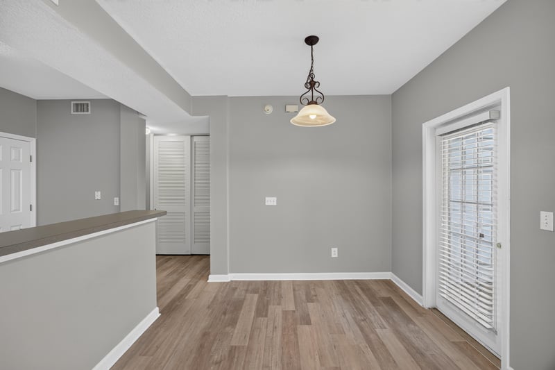 Dining area with pendant light and wood floor at 575 Oakleaf Plantation Pkwy, Orange Park, FL 32065