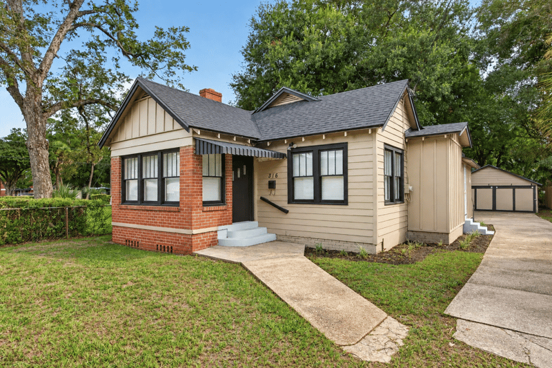 Front exterior with brick lower half, tan siding and covered porch at 316 W 41st St, Jacksonville, FL 32206
