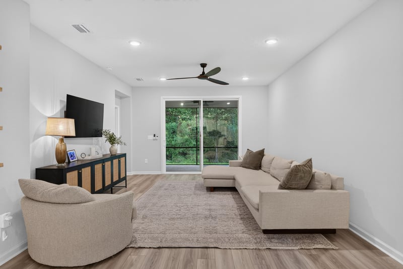 Living room with TV and sliding doors to backyard at 93 Lochloosa Ct, St. Johns, FL 32259