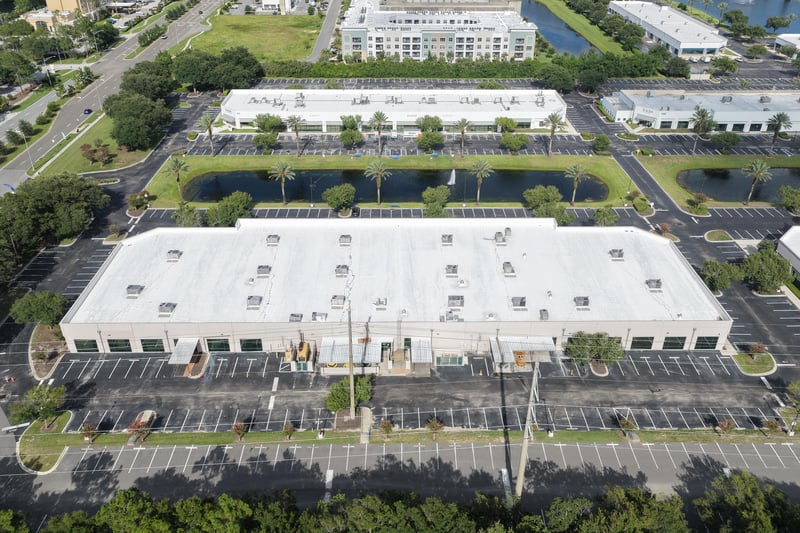 Aerial view of a roofline with ponds and multi-story buildings beyond at 10550 Deerwood Park Blvd, Jacksonville, FL 32256