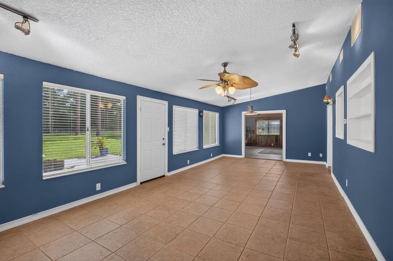 Lounge room with blue walls and ceiling fans at 5843 Ovella Rd, Jacksonville, FL 32244