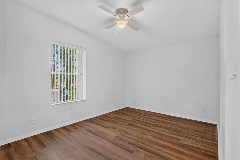 Bedroom with virtually staged bed and nightstand at 3215 Robin Ln, Middleburg, FL