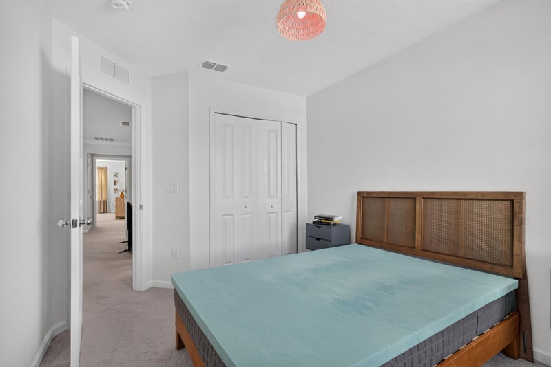 Secondary bedroom with bed and closet at 1186 Beach Dune Dr, Jacksonville, FL 32233