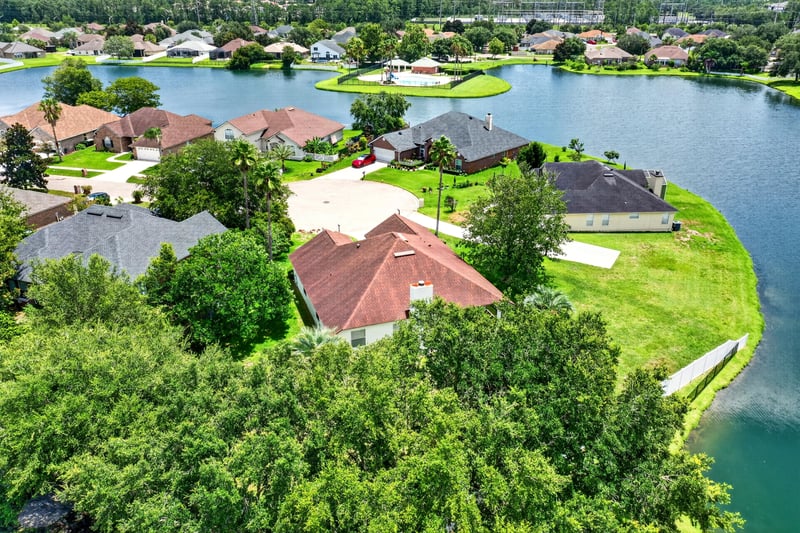 Aerial view of rooftops and a lake in Windsor Chase