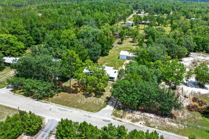 Aerial view of wooded lot and neighboring properties in Keystone Heights, FL