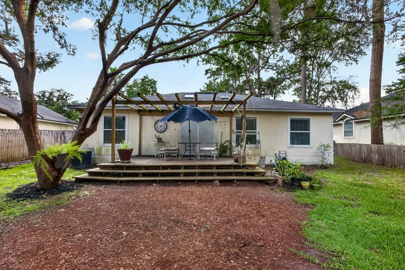 Backyard deck with pergola and trees at 145 Dover Bluff Dr, Orange Park, FL