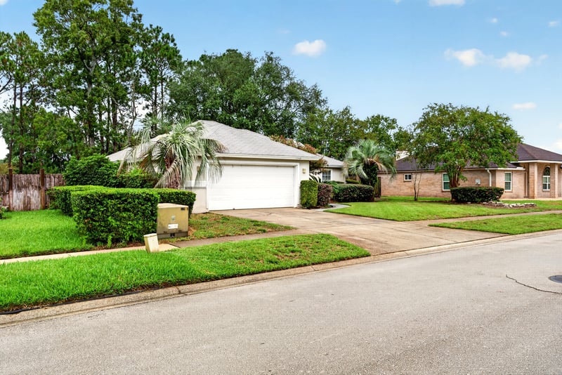 Street view of the driveway and front lawn at 12949 Chets Creek Dr S, Jacksonville, FL 32224