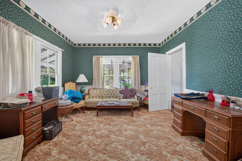 Bedroom with green patterned wallpaper at 1173 US-17, Satsuma, FL 32189