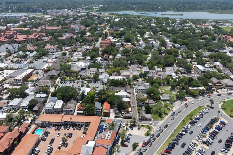 Aerial view of the historic district with a courtyard pool visible among rooftops in St. Augustine, FL