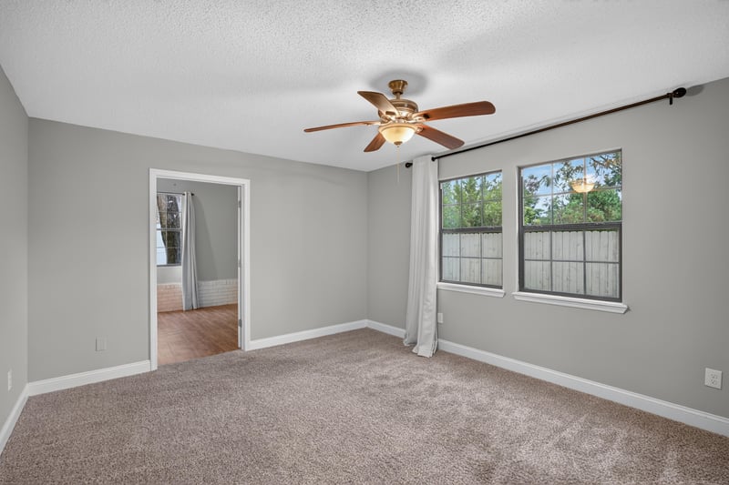 Carpeted bedroom with window at 12344 Cormorant Ct, Jacksonville, FL
