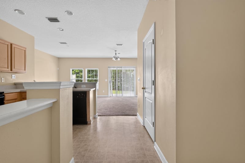 Hallway view from kitchen toward entry at 12359 Mangrove Forest Ct, Jacksonville, FL 32218