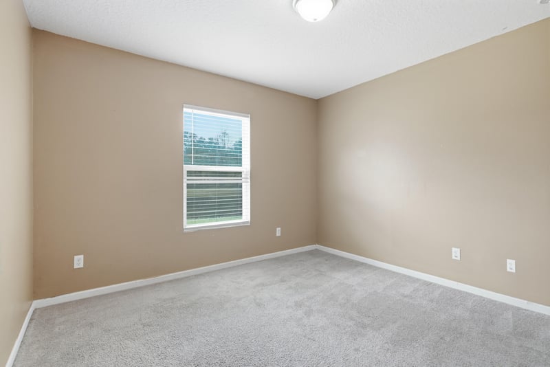 Empty room with window and carpet at 7392 Timber Falls Ct