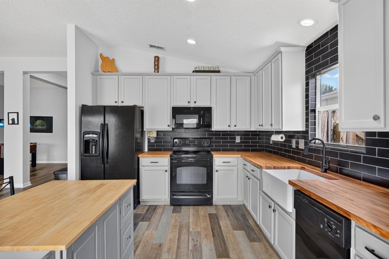 Kitchen with refrigerator and gray cabinetry at 2065 Creekmont Dr