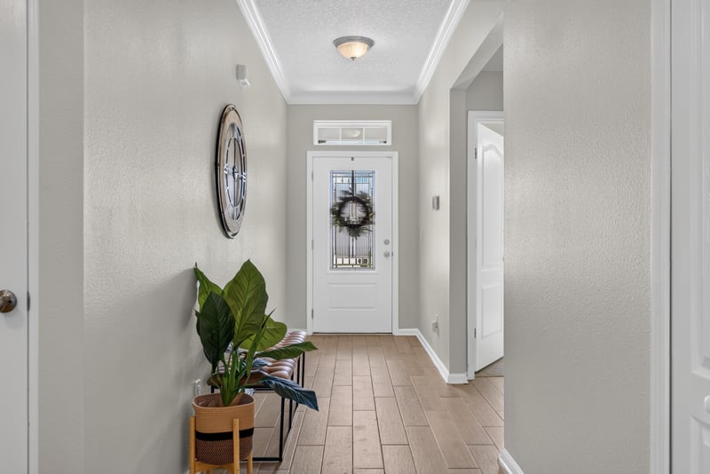 Foyer view toward the front door and wreath at 10066 Andean Fox Dr, Jacksonville, FL 32222