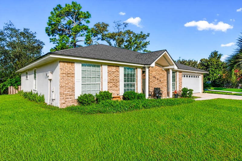 Brick ranch front exterior with white garage door at 4556 Shaky Leaf Ln N, Jacksonville, FL 32224