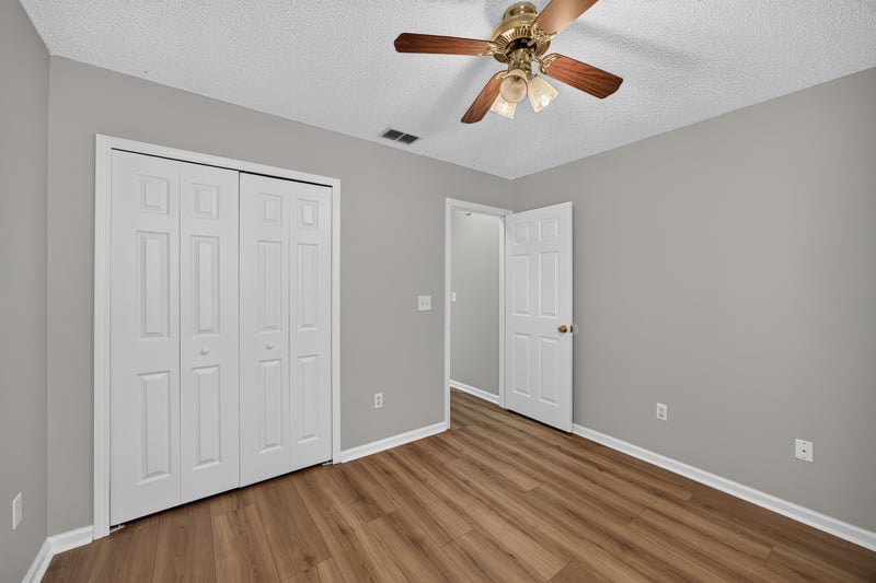 Bedroom with wood floor and closet doors at 9256 Dale View Ln W, Jacksonville, FL 32225
