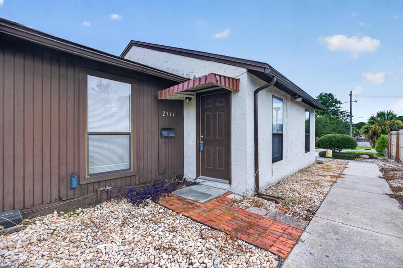 Front exterior with brick walkway and covered entry at 2717 Trollie Ln, Jacksonville, FL