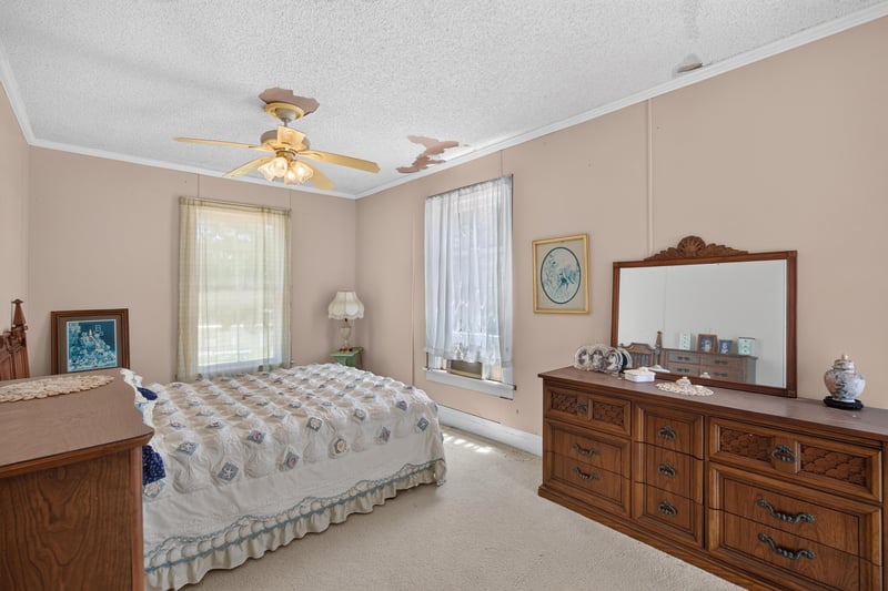 Bedroom with dresser and ceiling fan at 1173 US-17, Satsuma, FL 32189