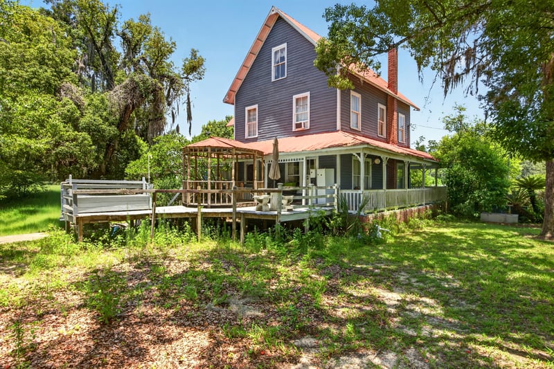 Aerial view of the home's porch and Spanish moss oaks at 1173 US-17, Satsuma, FL 32189