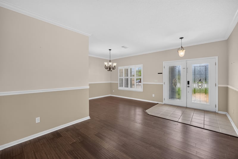 Living room with wood floors and French doors at 1493 Greyfield Dr, St. Augustine, FL 32092