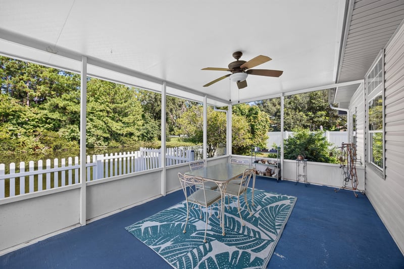 Screened porch with tile floor and rug at 11828 Heather Grove Ln, Jacksonville, FL