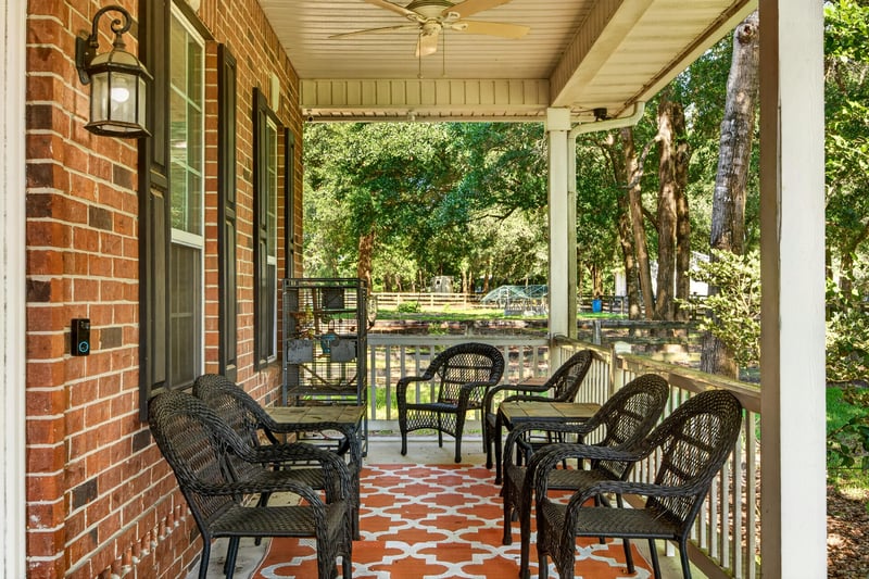 Front porch with seating and brick columns at 1735 Hagans Ridge Ct