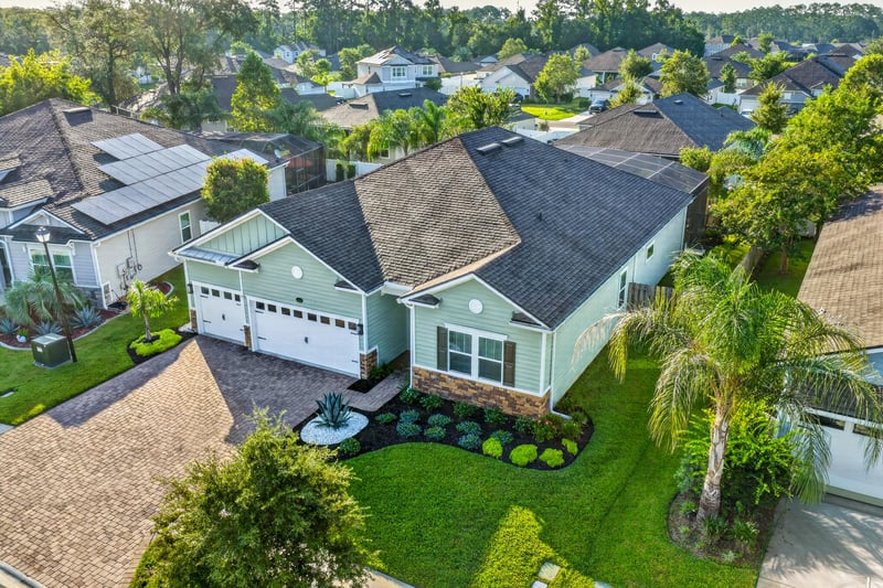 Aerial angled view of the home and driveway at 3328 Southern Oaks Dr, Green Cove Springs, FL 32043
