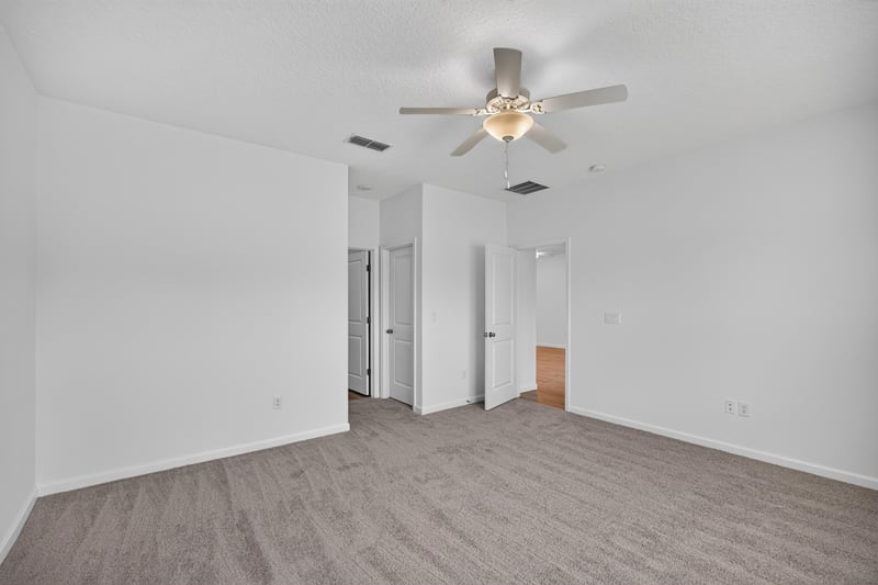 Hallway with ceiling fan and carpet flooring at 9905 Ansley Lake Dr, Jacksonville, FL