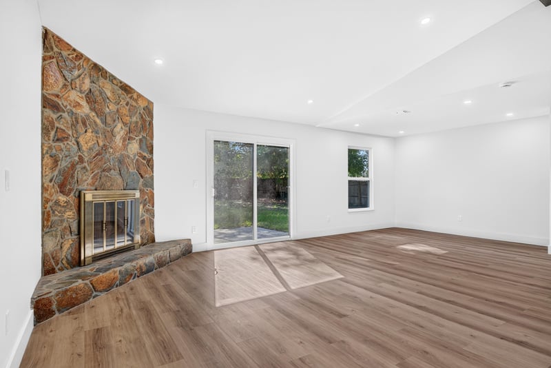 Stone fireplace and window in empty living room at 8453 Boysenberry Ln W, Jacksonville, FL
