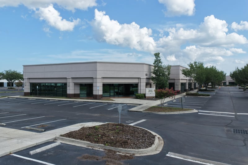 Building front with glass storefront and parking lot at 10550 Deerwood Park Blvd, Jacksonville, FL 32256