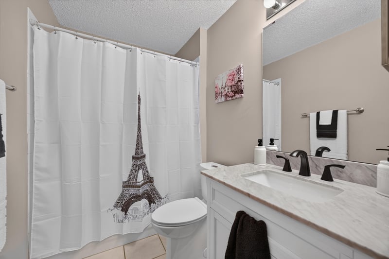 Bathroom with Eiffel Tower shower curtain and double vanity at 3067 Wavering Ln, Middleburg, FL 32068