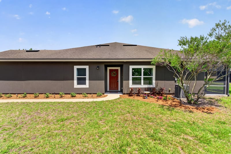 Front entry with red door and covered stoop at 2378 Caney Oaks Dr, Jacksonville, FL