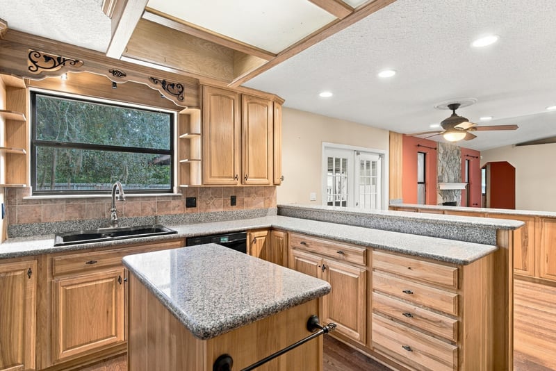 Kitchen sink area with window and wood cabinets at 2915 Trenton Ct, Orange Park, FL