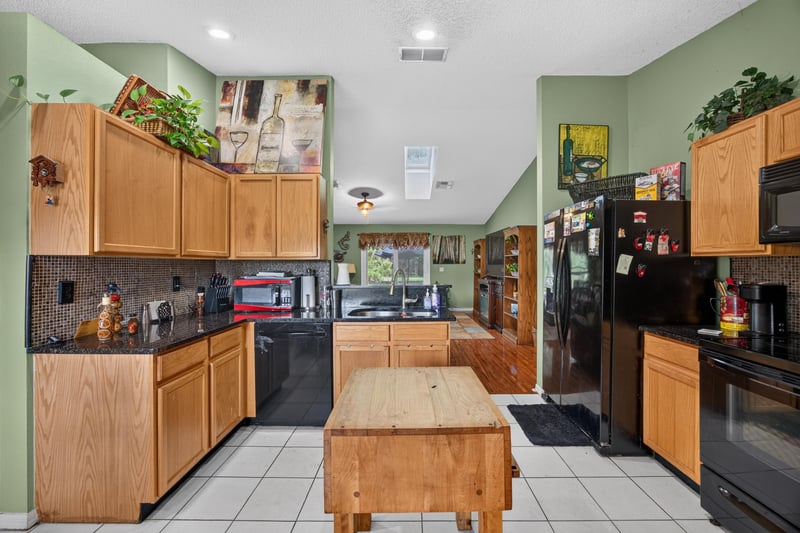 Kitchen with wood cabinets and tile floor at 145 Dover Bluff Dr, Orange Park, FL