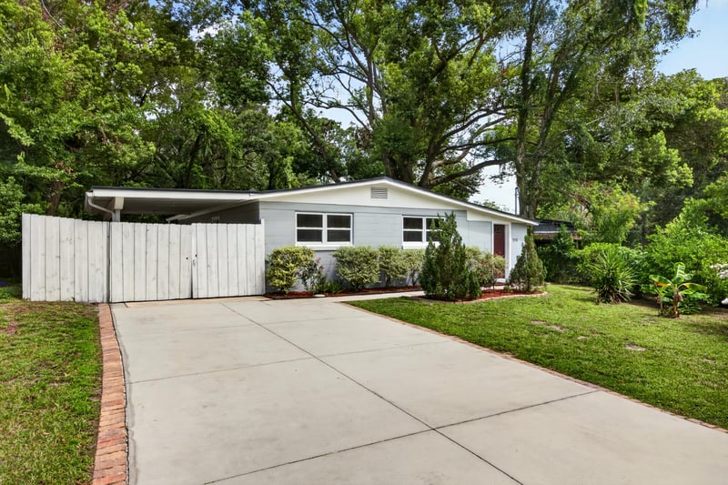 Front exterior with carport and concrete driveway at 7015 Miss Muffet Ln N, Jacksonville, FL 32210