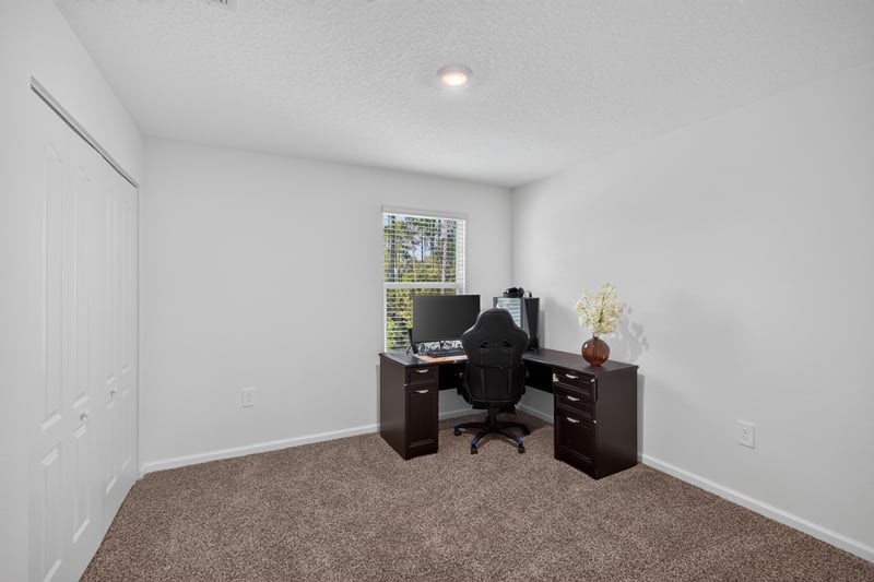 Bedroom or office with desk and computer at 65255 Frst Glen Ln, Yulee, FL 32097