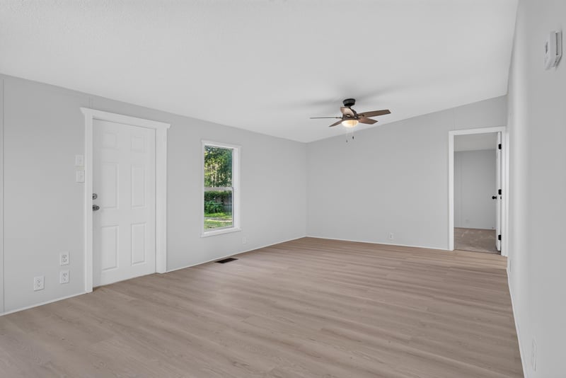 Open room with wood floor and ceiling fan at 55520 Jewel-Thomas Rd, Callahan, FL 32011