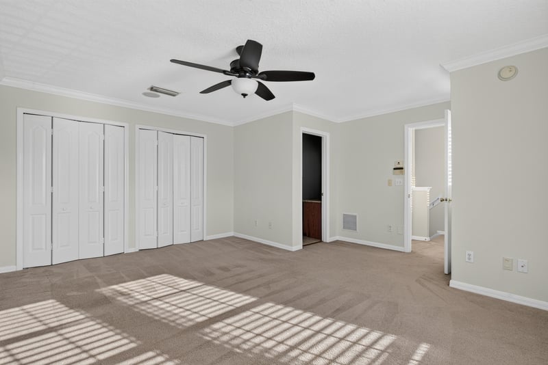 Bedroom with closet doors and carpet flooring at 353 Redwood Ln