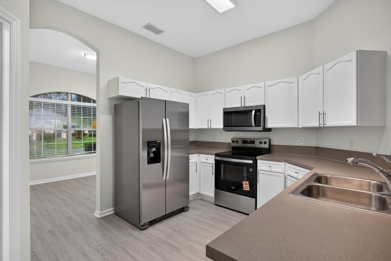 Kitchen with refrigerator, stove, and center island at 706 Bonaparte Dr, Jacksonville, FL 32218