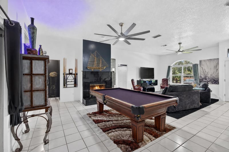 Living room with pool table and fireplace at 1346 Gately Ct, Jacksonville, FL 32225