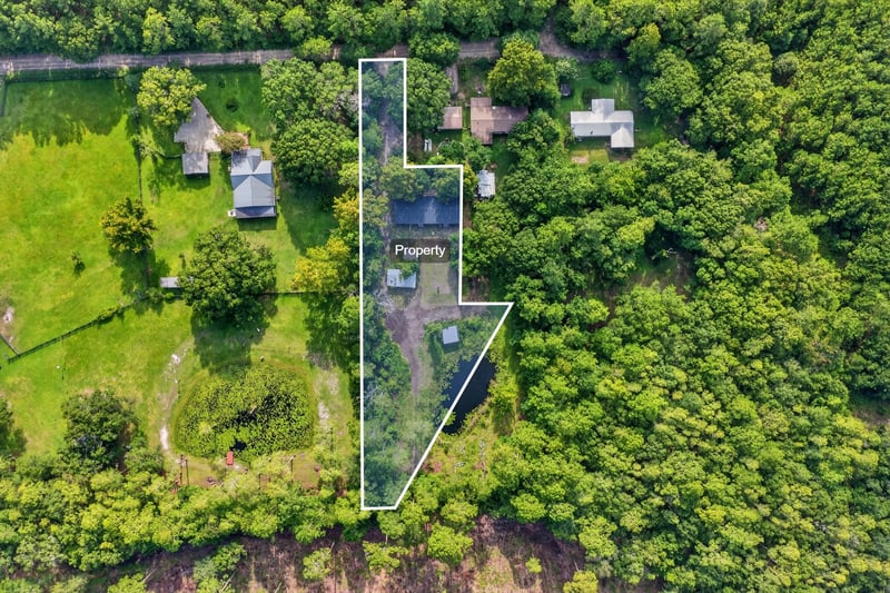 Aerial site overlay showing property boundary and wooded acreage at 55520 Jewel-Thomas Rd, Callahan, FL 32011