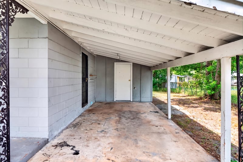 Covered carport with cinderblock wall at 4030 Leonard Cir W, Jacksonville, FL 32209