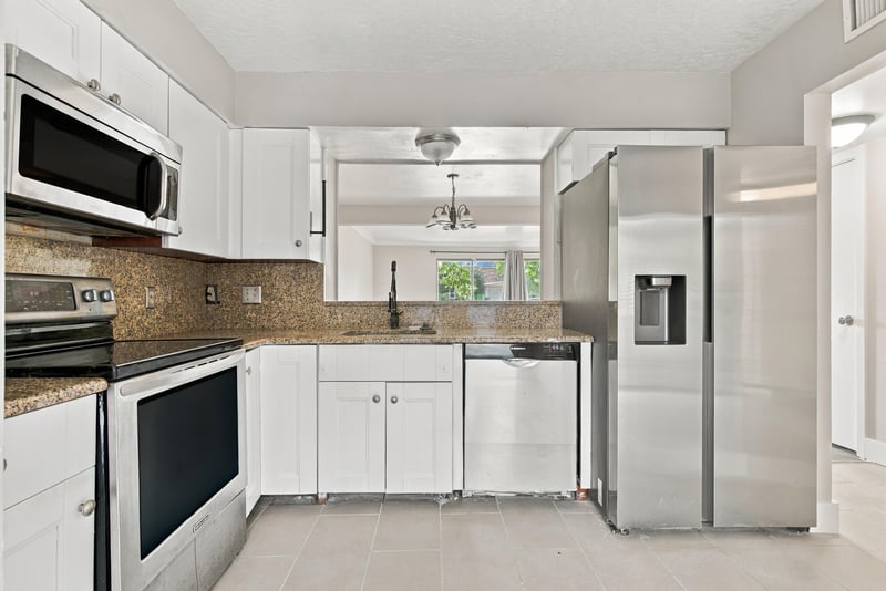 Kitchen with side-by-side refrigerator at 7703 Las Palmas Way