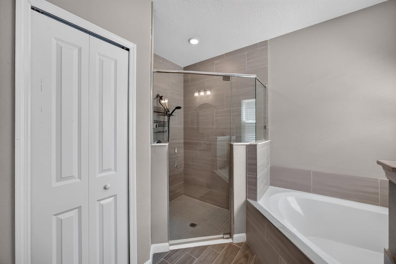 Primary bathroom walk-in shower with glass door at 9942 Lovage Ln, Jacksonville, FL 32219