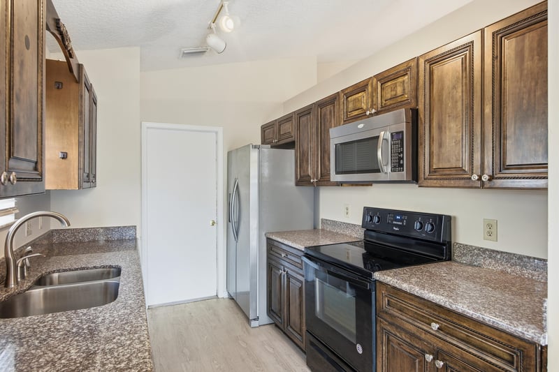 Kitchen with stainless microwave and black appliances at 678 5th Ave N, Jacksonville Beach, FL 32250