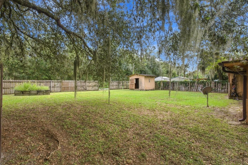 Backyard with trees along the property line at 2915 Trenton Ct, Orange Park, FL