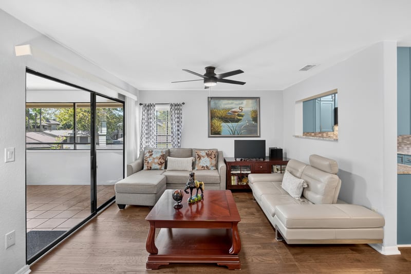 Living room with sliding glass doors and sofa at 10150 Belle Rive Blvd, Jacksonville, FL